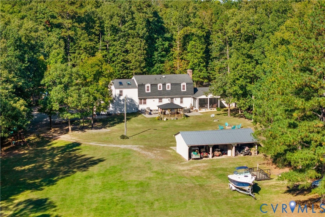 12380 Bienvenue Road, Bowles Acres, Rockville, VA 23146 Two-story residence featuring a multi-dormer roofline, skylights, an attached screened porch, a detached multi-bay open-air structure, and7. 9 acreage