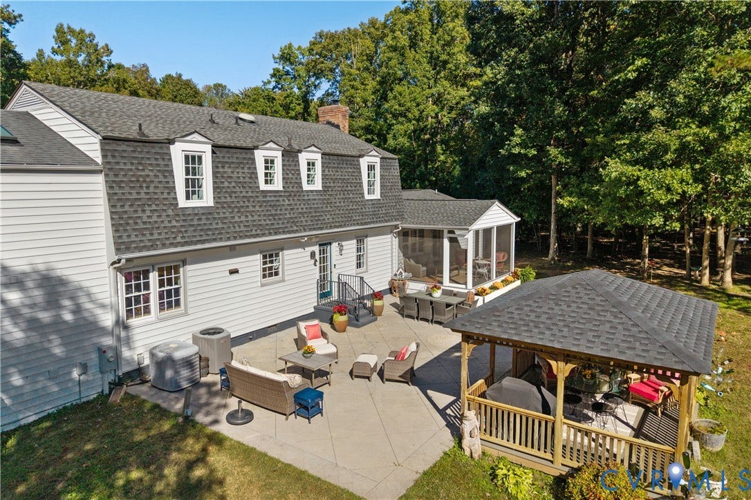 12380 Bienvenue Road, Bowles Acres, Rockville, VA 23146 Rear exterior featuring a gambrel roof, light-toned horizontal siding,concrete patio, covered gazebo, and an screened porch