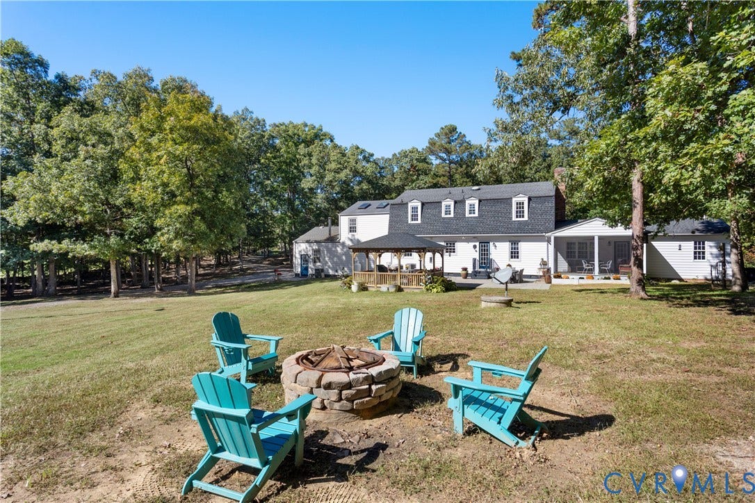 12380 Bienvenue Road, Bowles Acres, Rockville, VA 23146 Expansive backyard featuring a stone fire pit, a covered gazebo, and a rear porch with mature trees