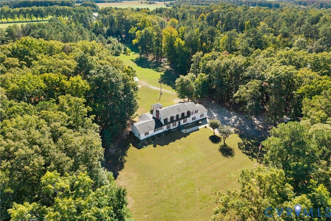 12380 Bienvenue Road, Bowles Acres, Rockville, VA 23146 Multi-story residence featuring a shingled roof, exterior brick chimney, sprawling grounds, and extensive perimeter woodland