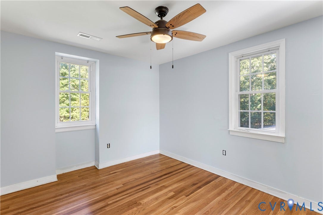 12380 Bienvenue Road, Bowles Acres, Rockville, VA 23146 Room featuring wood-finish flooring, two multi-pane windows, and a ceiling fan with integrated lighting