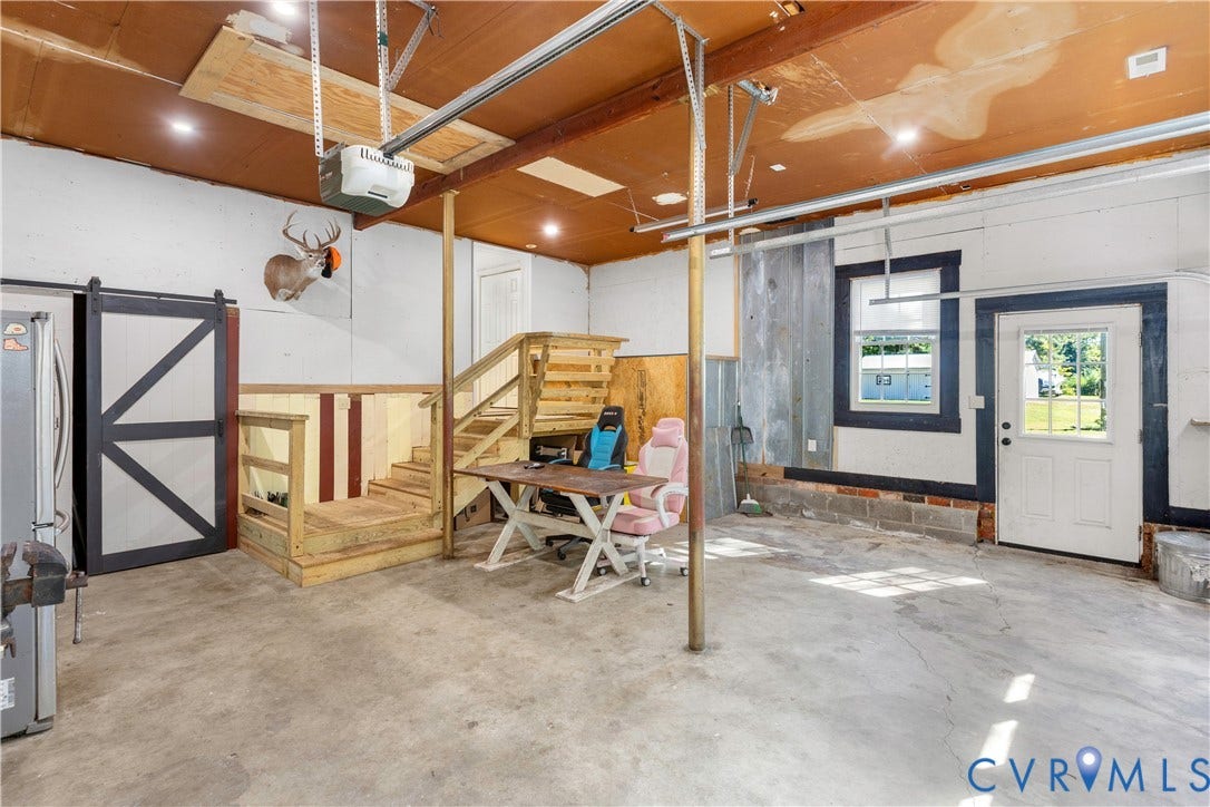 12380 Bienvenue Road, Bowles Acres, Rockville, VA 23146 Multi-purpose space featuring concrete flooring, a wooden staircase, sliding barn-style door, and recessed lighting