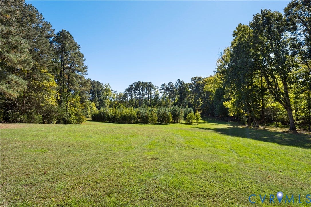 12380 Bienvenue Road, Bowles Acres, Rockville, VA 23146 Expansive parcel featuring open green space, cleared acreage, and mature tree borders