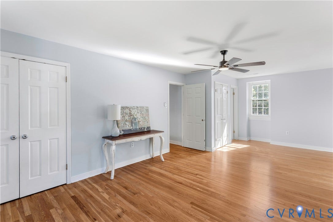 12380 Bienvenue Road, Bowles Acres, Rockville, VA 23146 2nd floor primary Room featuring wood-newly finished flooring, a multi-panel ceiling fan with integrated lighting, dual-panel closet doors, and a multi-pane window