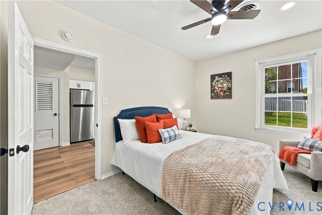 Neutral wall finishes, recessed lighting, ceiling fan with integrated light fixture, multi-pane window, and wood-finish flooring