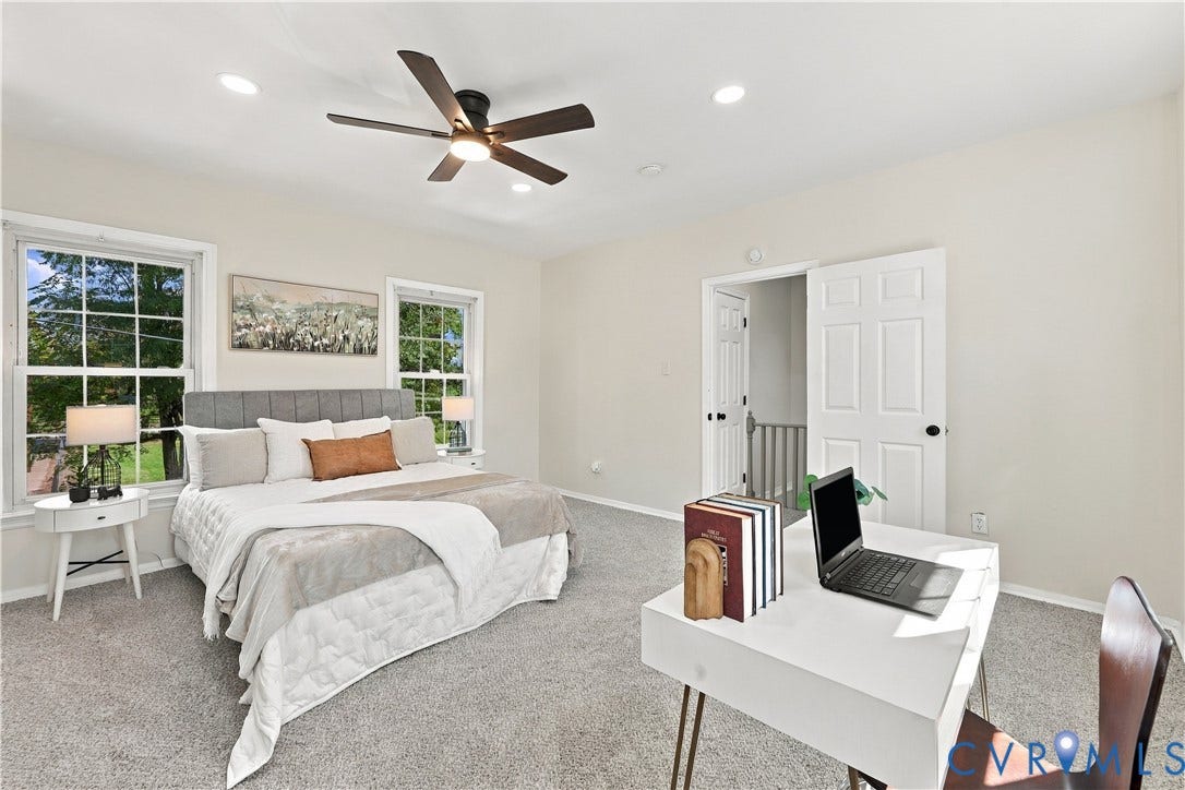 Neutral-toned room featuring wall-to-wall carpeting, recessed lighting, a multi-blade ceiling fan with integrated light, and two double-hung windows