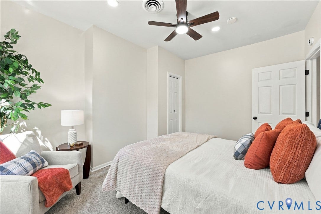 Neutral-toned interior space featuring recessed lighting, a ceiling fan with integrated light fixture, wall-to-wall carpeting, and a multi-panel interior door