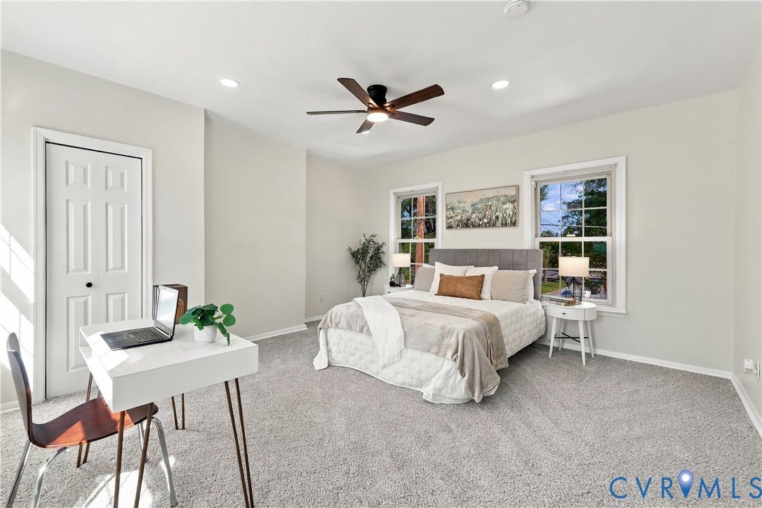 Neutral-toned room featuring plush wall-to-wall carpeting, recessed lighting, a modern ceiling fan, and two double-hung windows