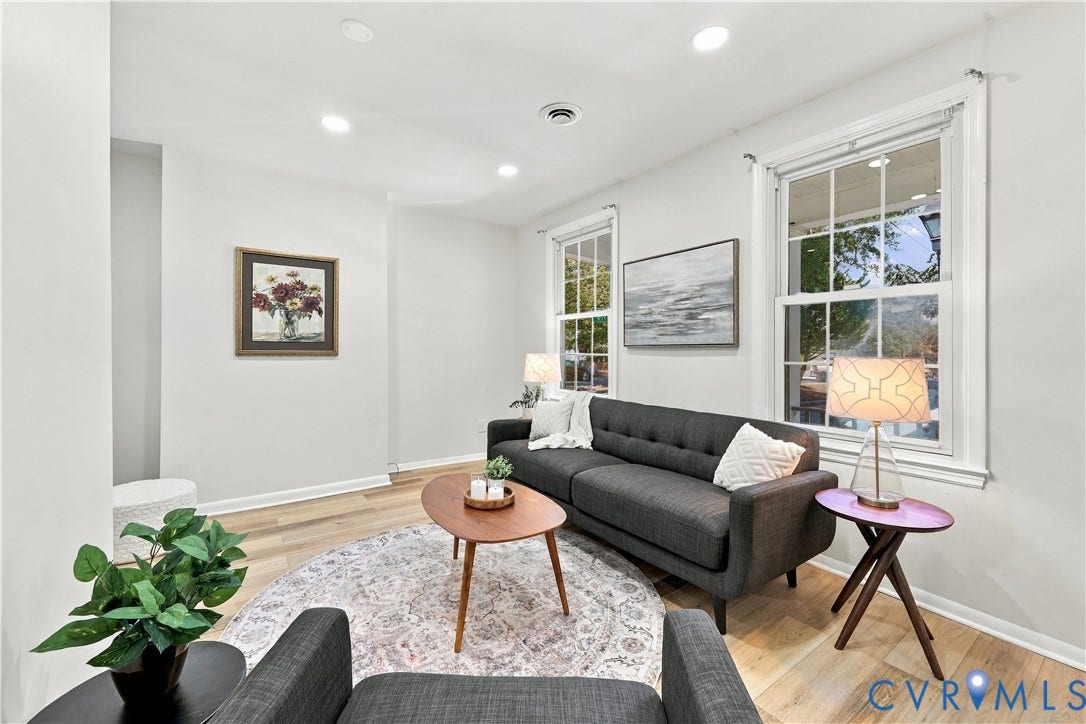 Bright interior space featuring light wood-finish flooring, recessed lighting, and double-hung windows with exterior muntins