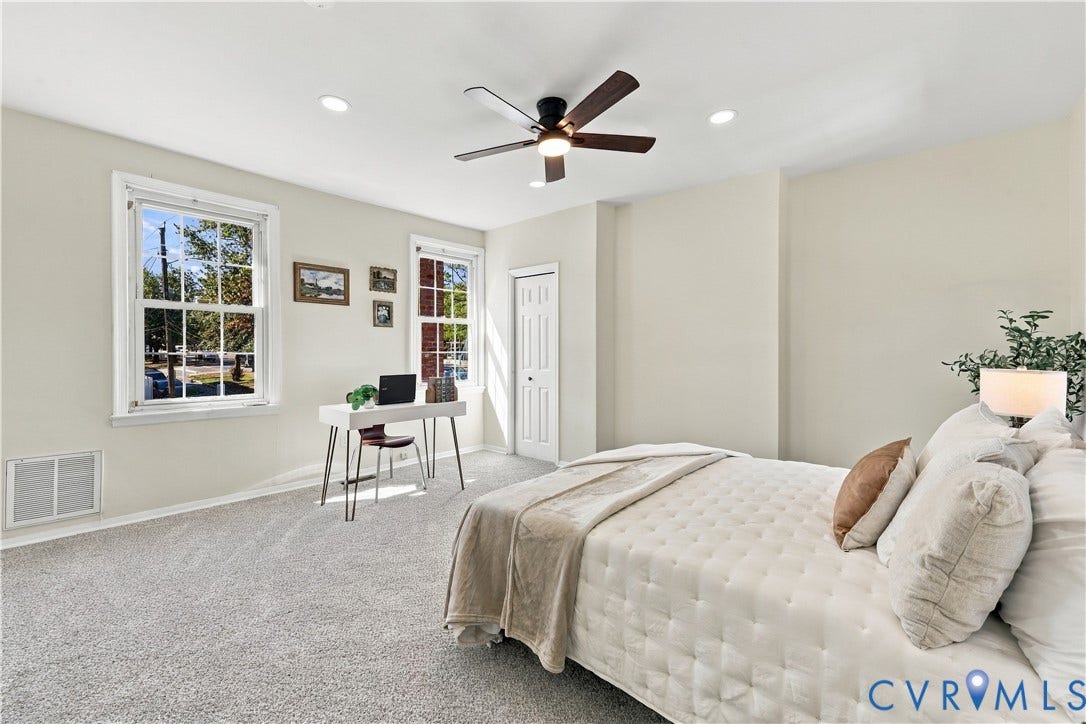 Neutral wall palette featuring dual windows with traditional trim, plush wall-to-wall carpeting, recessed lighting, and a ceiling fan with integrated lighting