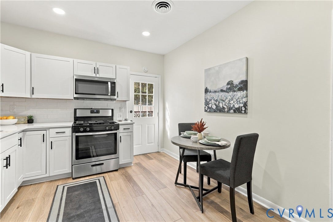 Kitchen featuring white cabinetry, stainless steel appliances, wood-finish flooring, recessed lighting, and a glass-paneled exterior door