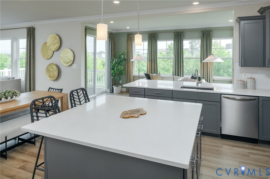 Contemporary kitchen with two kitchen islands, stainless steel appliances, and wood-finish flooring