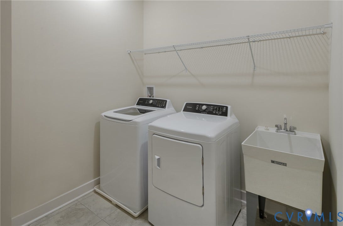 Laundry area featuring a utility sink with a chrome faucet, washer, dryer, and an overhead wire shelf