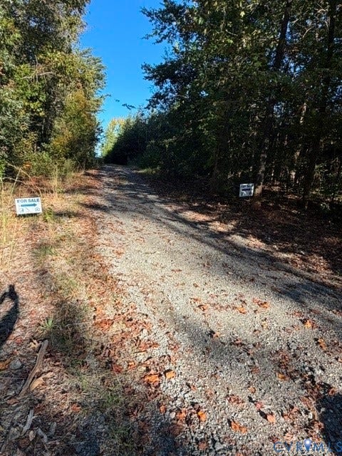 0 Hadensville Fife Road, Goochland, VA 23063 Gravel Driveway towards property. The signs indicate where the easement would begin for the available lot.