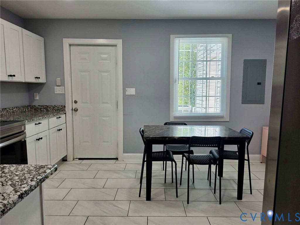 1351 Minefee Street, Bellemeade, Richmond, VA 23224 Eat-in style kitchen featuring granite countertops, ceramic tile, stainless steel appliances, white cabinets with matte black pulls & a stack, washer and dryer.