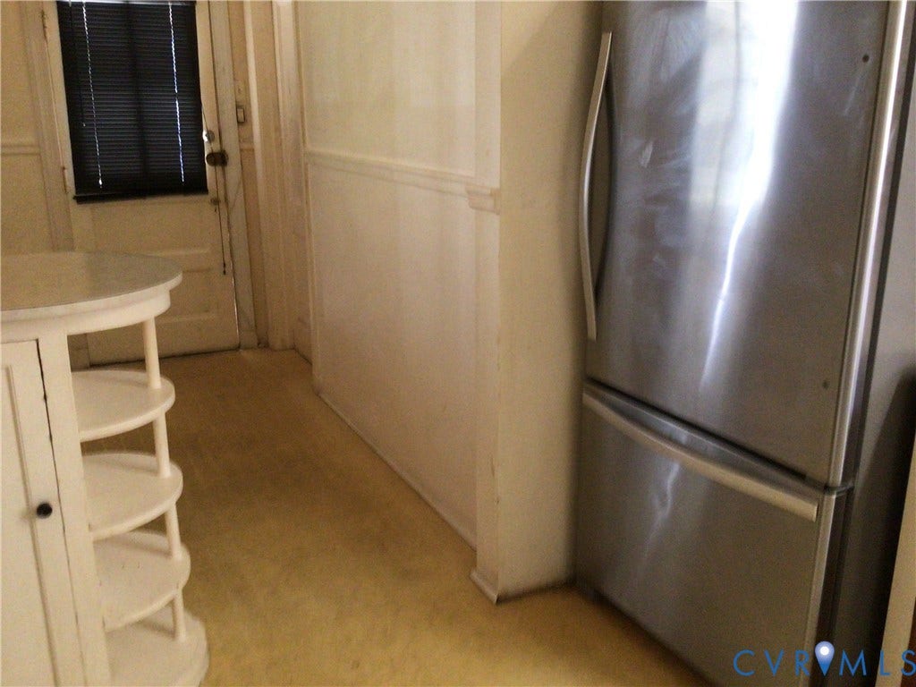 1307 Greystone Avenue, Richmond, VA 23224 Stainless steel refrigerator and white built-in corner shelving with a circular countertop
