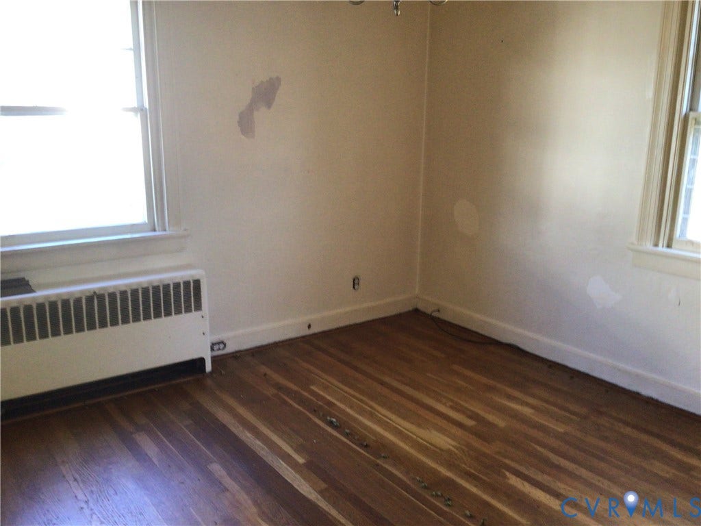 1307 Greystone Avenue, Richmond, VA 23224 Wood-finish flooring, two large windows, and a built-in radiator unit