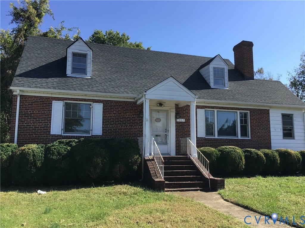 1307 Greystone Avenue, Richmond, VA 23224 Cape Cod-style residence featuring a red brick exterior, front gable roofline with dual dormers, a covered entryway, and a masonry chimney