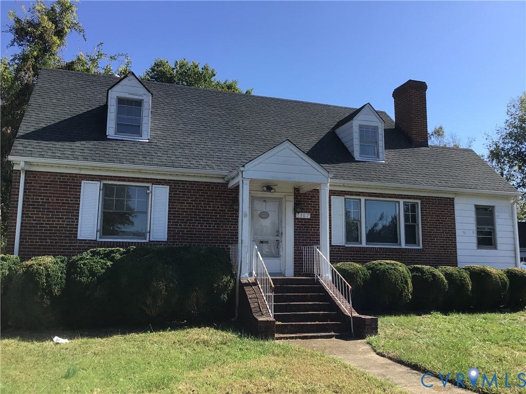 1307 Greystone Avenue, Richmond, VA 23224 Cape Cod style exterior featuring a brick and siding facade, gabled dormers, a covered entryway, and a masonry chimney