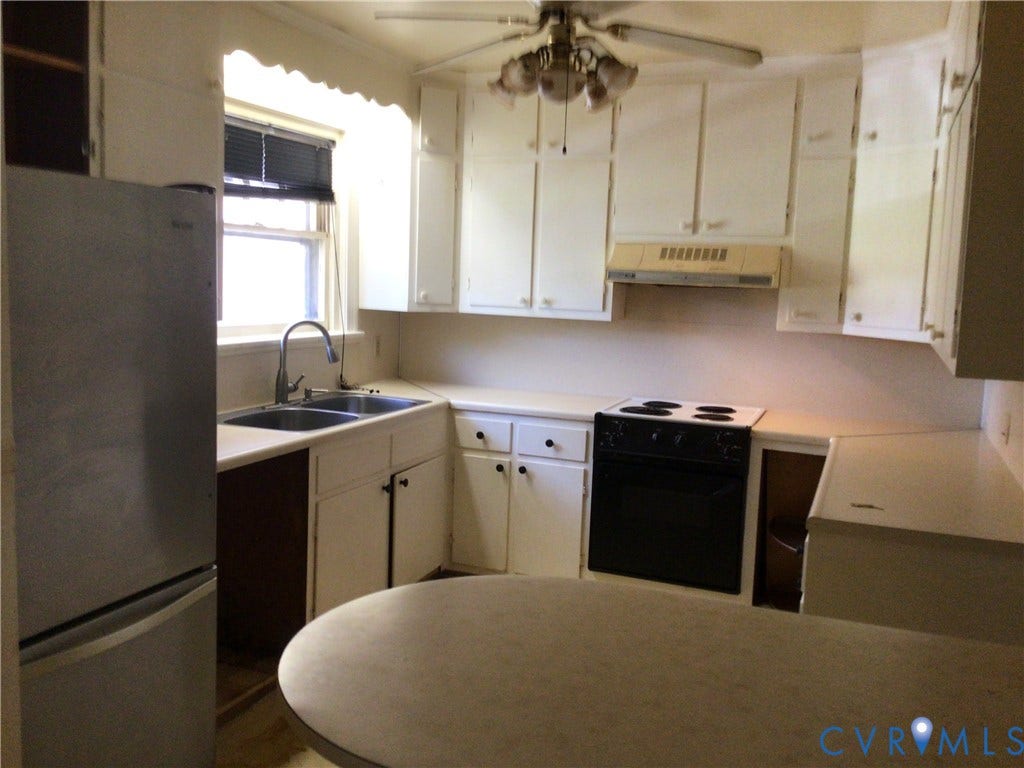 1307 Greystone Avenue, Richmond, VA 23224 Kitchen featuring white cabinetry, stainless steel sink with gooseneck faucet, black electric range, and integrated ceiling fan with lighting