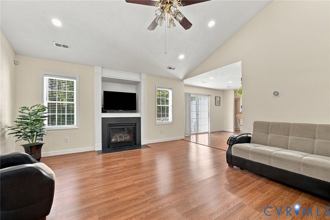 8119 Castle Grove Drive, Mechanicsville, VA 23111 Living Room with Vaulted ceilings, wood-finish flooring, built-in fireplace with recessed media niche, and recessed lighting
