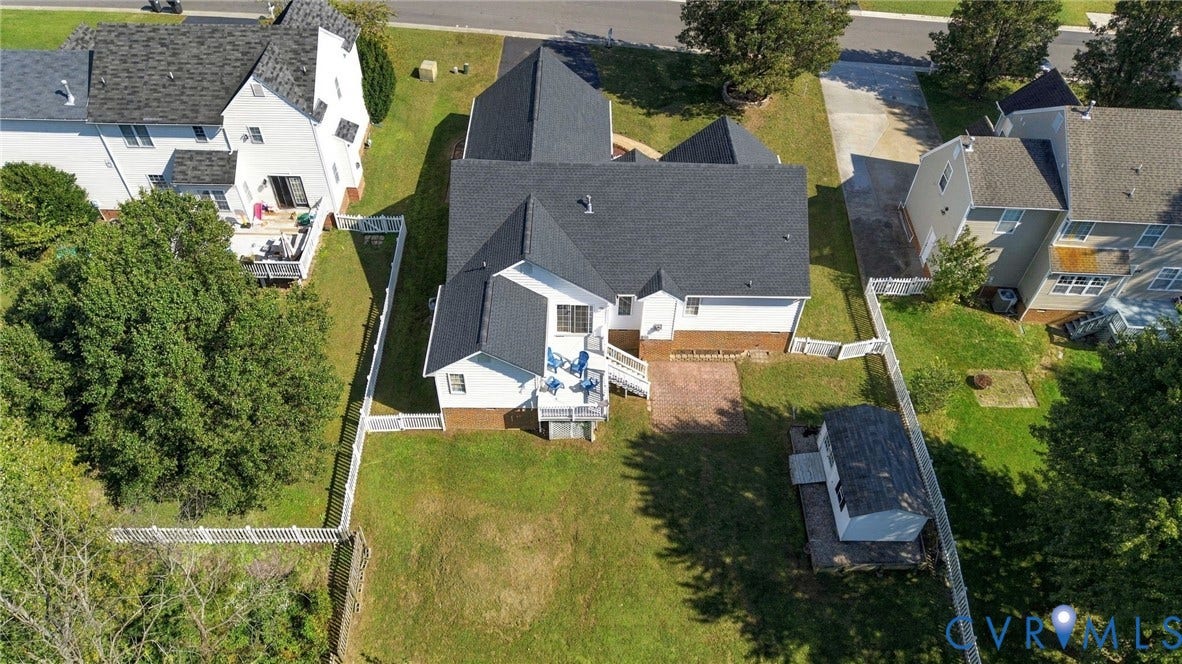 8119 Castle Grove Drive, Mechanicsville, VA 23111 Aerial perspective of property featuring a multi-level asphalt shingle roof, brick and siding exterior, raised deck, brick patio, and fenced backyard