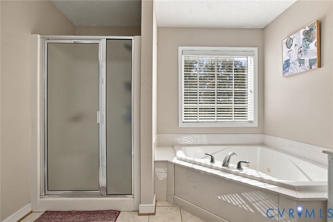 8119 Castle Grove Drive, Mechanicsville, VA 23111 Primary barhroom with Walk-in shower with a frosted glass door, corner soaking tub, integrated deck, and window with horizontal blinds