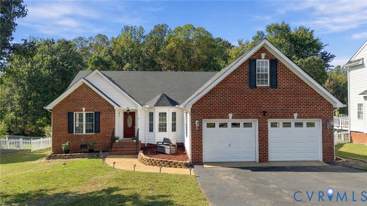 8119 Castle Grove Drive, Mechanicsville, VA 23111 Traditional brick and siding exterior featuring a multi-gabled roofline, front-facing bay window, arched entryway with decorative glass door, and an attached two-car garage