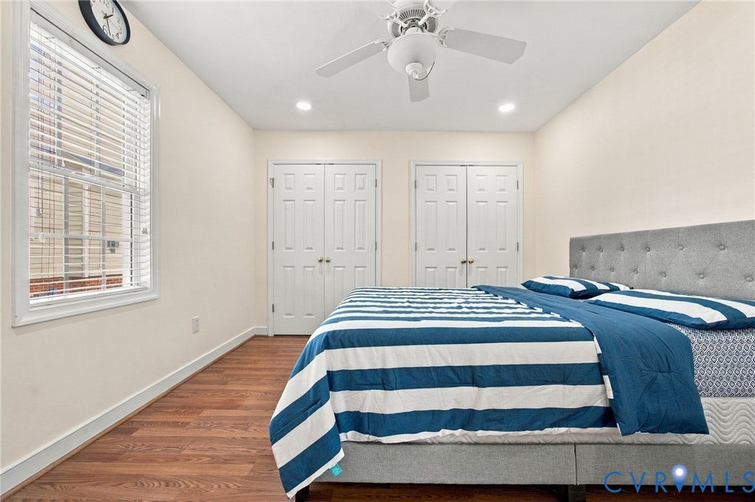 8119 Castle Grove Drive, Mechanicsville, VA 23111 Bedroom with Wood-finish flooring, dual sets of double-panel closet doors, recessed lighting, and a white ceiling fan with integrated light fixture