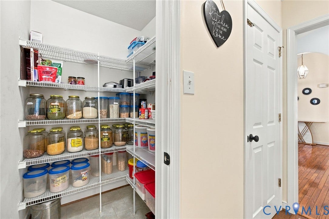 8119 Castle Grove Drive, Mechanicsville, VA 23111 Walk-in pantry featuring white wire shelving and neutral tile flooring, enclosed by a six-panel door