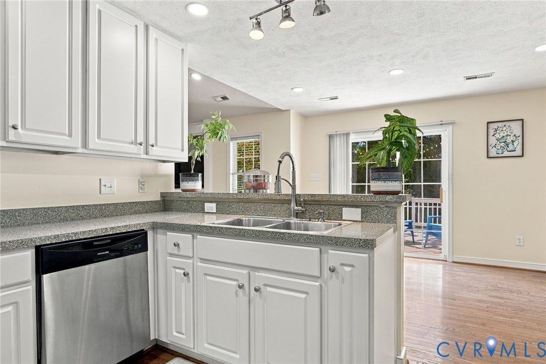 8119 Castle Grove Drive, Mechanicsville, VA 23111 Kitchen featuring white cabinetry, stone-finish countertops, a stainless steel dishwasher, a dual-basin stainless steel sink with a high-arch faucet, and wood-finish flooring