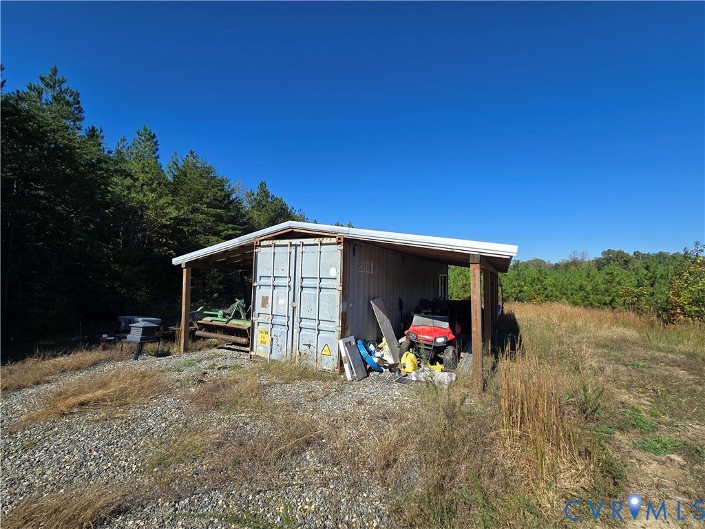 Lot 7 Saw Mill Road, Sawmill, Buckingham, VA 23901 Steel storage container structure featuring an open-sided pole barn roof and gravel ground cover
