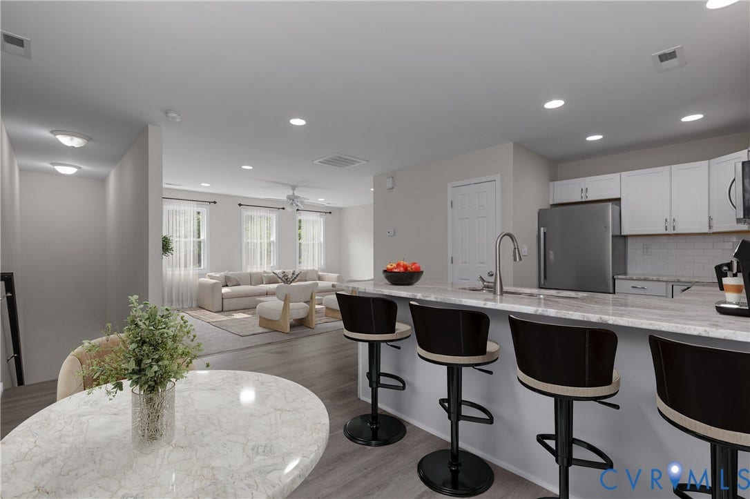 12089 Monterey Road, Ruther Glen, VA 22546 Kitchen featuring stone-patterned countertops, a breakfast bar, recessed lighting, white cabinetry, and stainless steel appliances, set against wood-finish flooring