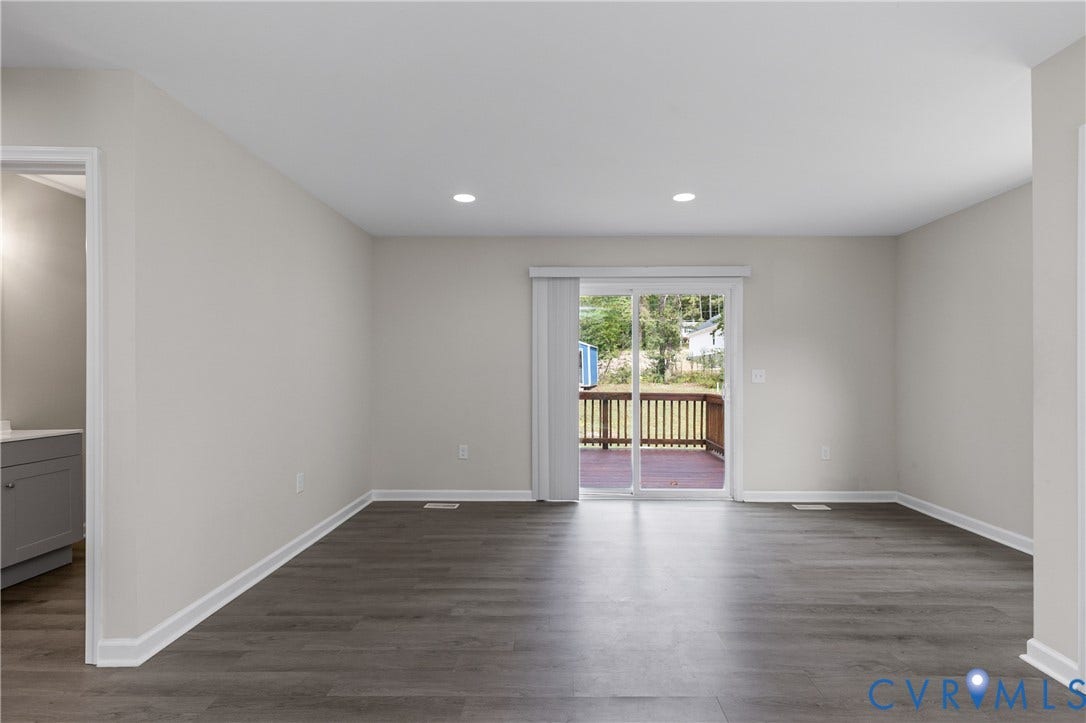 12089 Monterey Road, Ruther Glen, VA 22546 Neutral interior featuring wood-finish flooring, recessed lighting, and a glass sliding door providing outdoor deck access