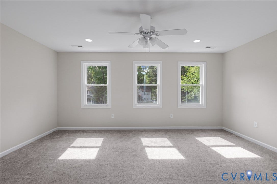 12089 Monterey Road, Ruther Glen, VA 22546 Neutral wall palette, carpeted flooring, triple window configuration, and overhead ceiling fan with integrated lighting