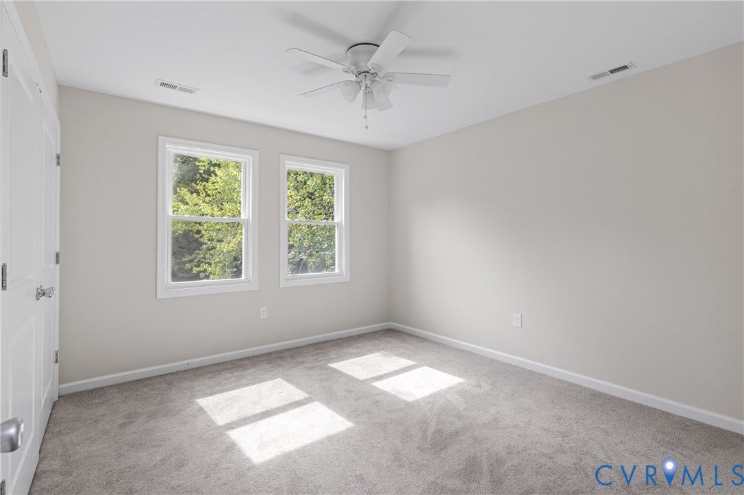 12089 Monterey Road, Ruther Glen, VA 22546 Neutral interior space featuring carpeting, white walls, dual-pane windows, and a ceiling fan with integrated light fixture