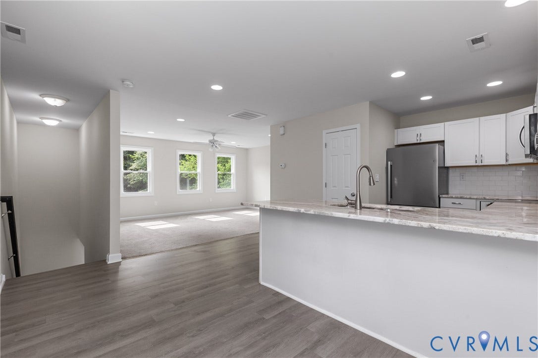 12089 Monterey Road, Ruther Glen, VA 22546 Kitchen featuring stone-finish countertops, stainless steel refrigerator, white cabinetry, tile backsplash, and recessed lighting