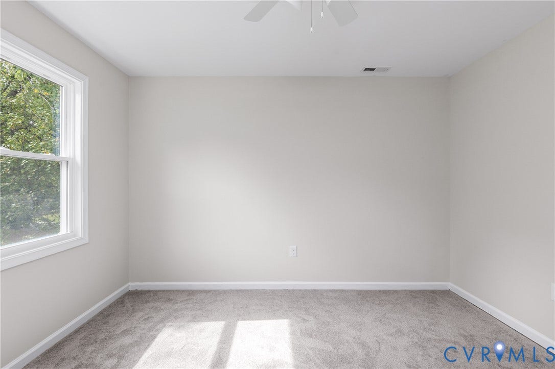 12089 Monterey Road, Ruther Glen, VA 22546 Neutral-toned interior space featuring wall-to-wall carpeting, a single-hung window, and a ceiling-mounted fan