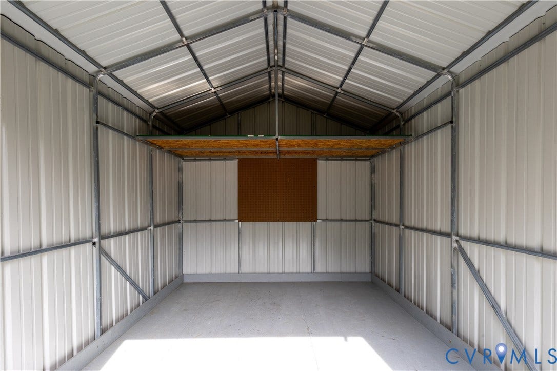 12089 Monterey Road, Ruther Glen, VA 22546 Outbuilding featuring a corrugated metal exterior, vaulted ceiling, metal structural framing, and an elevated storage platform