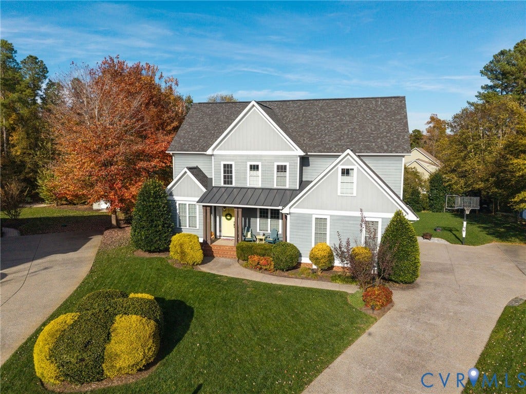 4502 Jennway Turn, Summer Lake, Moseley, VA 23120 Two-story exterior featuring light gray horizontal siding, a gabled roofline with asphalt shingles, metal roof accents, and a concrete driveway