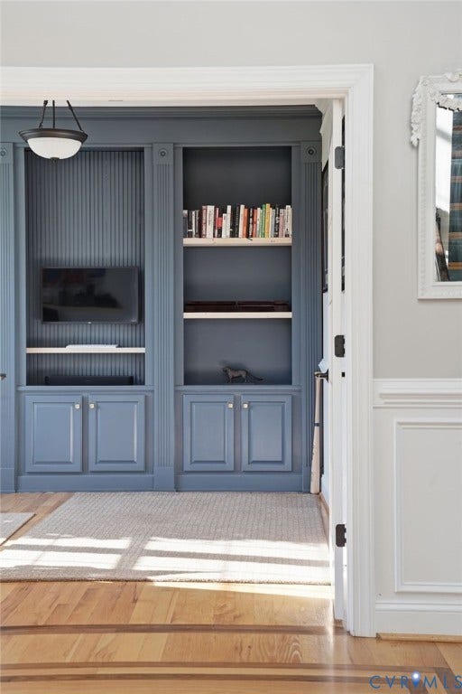 4502 Jennway Turn, Summer Lake, Moseley, VA 23120 Custom built-in cabinetry featuring fluted detailing, lower storage cupboards, open shelving, integrated beadboard paneling, and an attached semi-flush mount light fixture