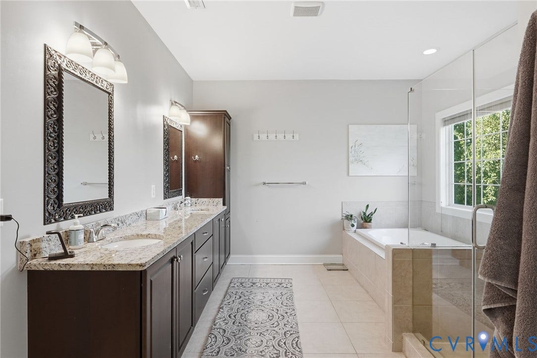 4502 Jennway Turn, Summer Lake, Moseley, VA 23120 Double vanity with stone countertop, dark wood-finish cabinetry, tile flooring, glass-enclosed shower, and a built-in soaking tub