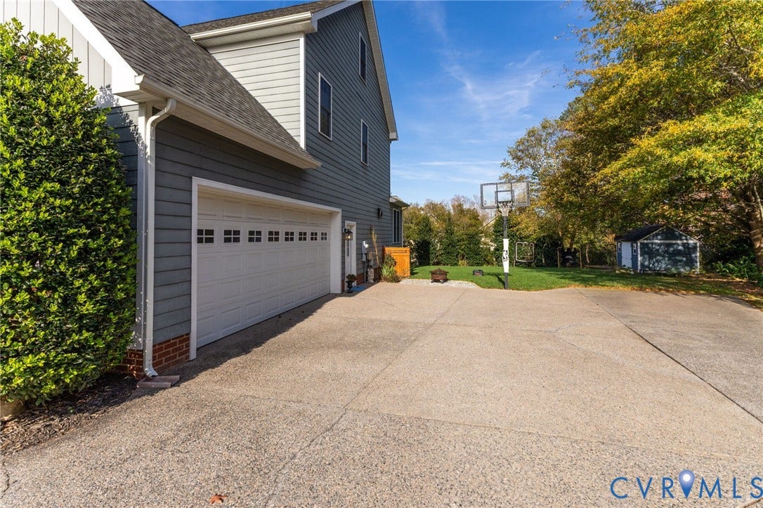 4502 Jennway Turn, Summer Lake, Moseley, VA 23120 Horizontal lap siding exterior, attached multi-car garage, expansive concrete driveway, and detached storage structure