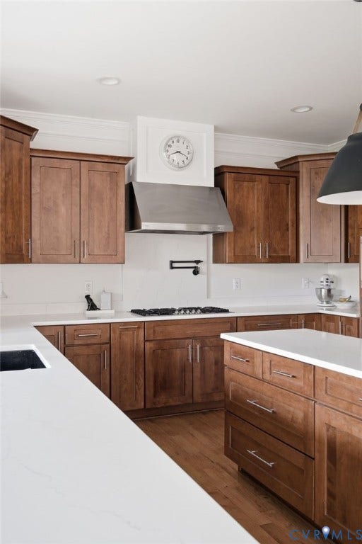 4502 Jennway Turn, Summer Lake, Moseley, VA 23120 Kitchen featuring wood cabinetry, white stone-finish countertops, stainless steel range hood, wall-mounted pot filler, and wood-finish flooring