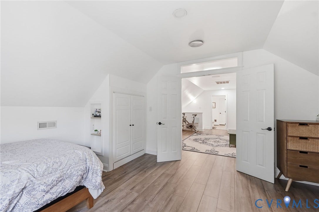 4502 Jennway Turn, Summer Lake, Moseley, VA 23120 Wood-finish flooring, vaulted ceilings, integrated wall storage, and dual-panel interior doors with transom window detail
