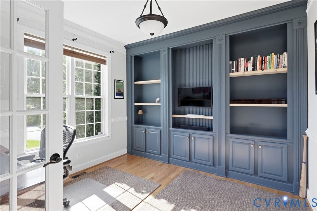 4502 Jennway Turn, Summer Lake, Moseley, VA 23120 Built-in floor-to-ceiling cabinetry with decorative fluting, wood-finish flooring, multi-pane glass French doors, and an overhead semi-flush mount light fixture