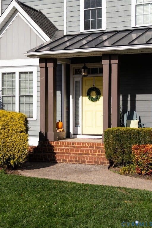 4502 Jennway Turn, Summer Lake, Moseley, VA 23120 Covered front porch featuring brick steps, metal roofing, square columns, and a paneled entry door with a sidelight
