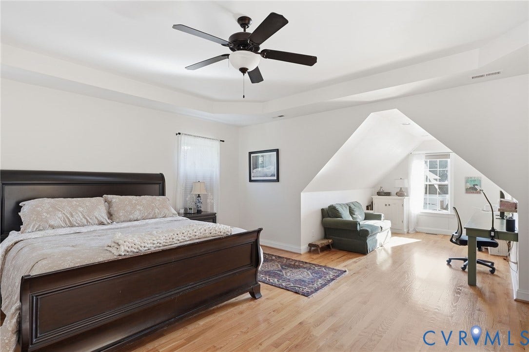 4502 Jennway Turn, Summer Lake, Moseley, VA 23120 Tray ceiling, wood-finish flooring, and multi-paned windows featuring architectural dormer alcoves and an attached ceiling fan with integrated lighting