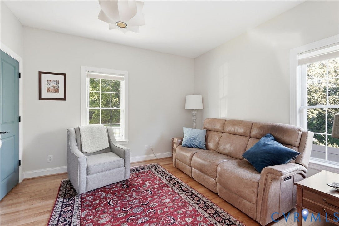 4502 Jennway Turn, Summer Lake, Moseley, VA 23120 Neutral-toned walls, wood-finish flooring, dual windows with white casing, and geometric ceiling fixture