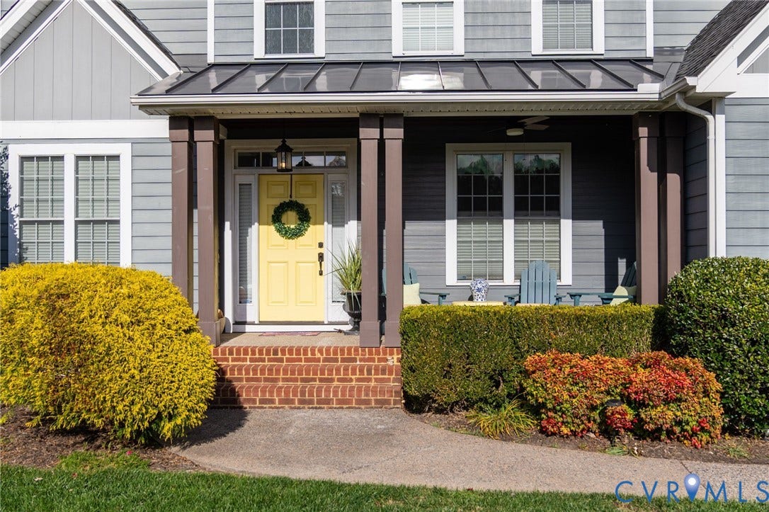 4502 Jennway Turn, Summer Lake, Moseley, VA 23120 Covered front porch featuring a metal roof, brick steps, and square support pillars, accented by horizontal lap siding